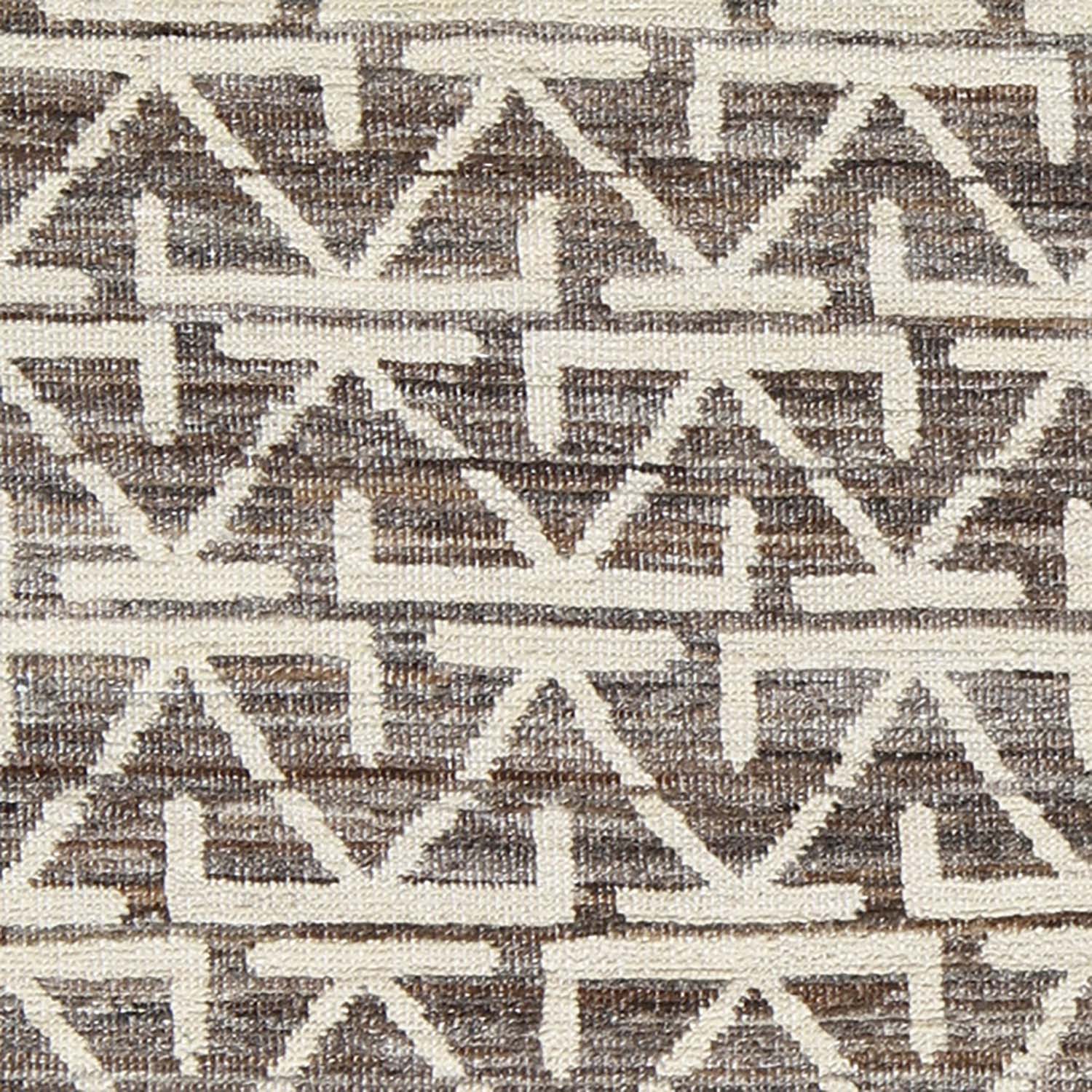 Geometric patterned fabric with triangles and diamond-like figures in neutral colors.
