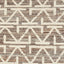 Close-up of a cream geometric patterned fabric or carpet texture.