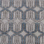 Close-up of ornate, geometric fabric pattern in neutral tones.