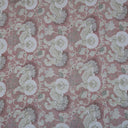 Intricate floral pattern on muted reddish-pink fabric; perfect for home decor.