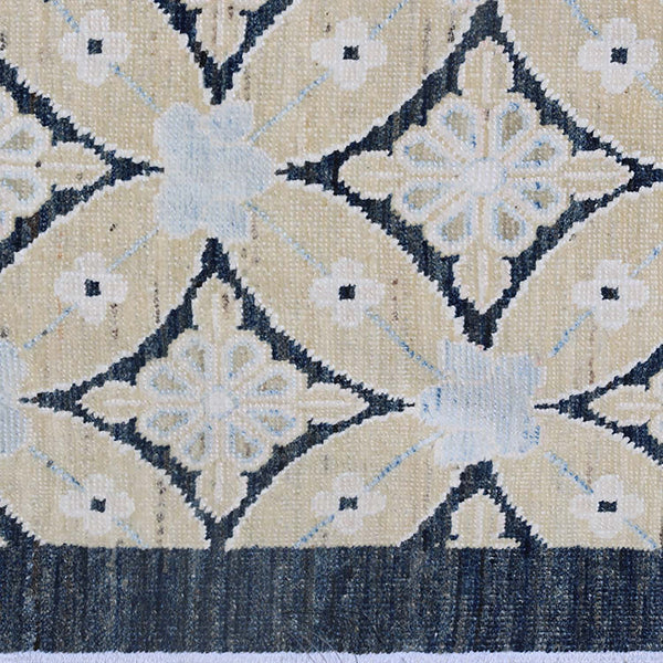 Intricate symmetrical floral pattern on a dark textile fabric close-up.