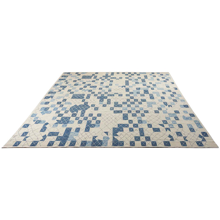 Abstract mosaic of blue and off-white tiles creates mesmerizing pattern.