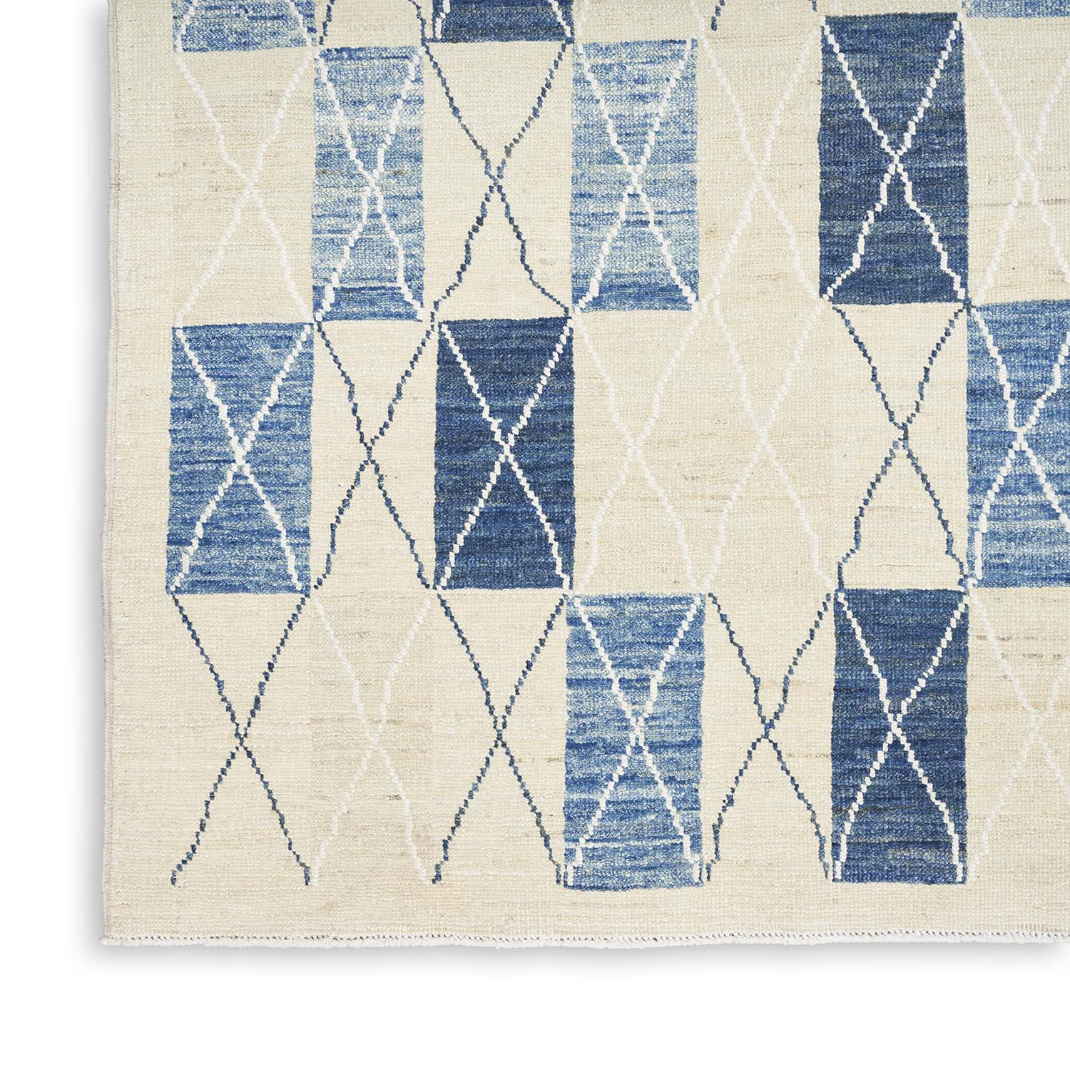 Contemporary rug with blue and white diamond pattern displays artisanal charm.