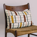 Traditional wooden chair with woven rattan seat and decorative pillow