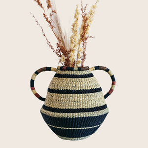 Handcrafted woven basket with precision stripes and decorative handle. - hover