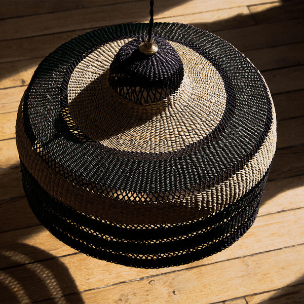 Handcrafted woven basket lid with intricate pattern; versatile use suggested.