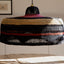 Artisanal pendant lamp with woven material adds warmth and style.