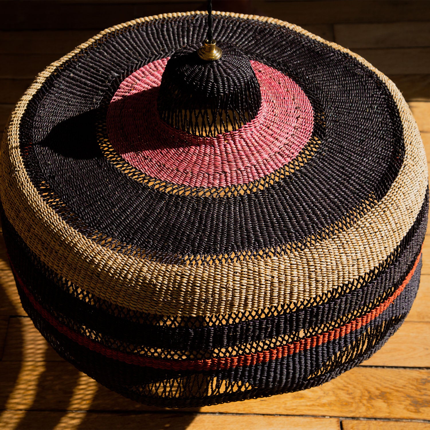 Exquisite handwoven African basket with intricate pattern and vibrant colors.