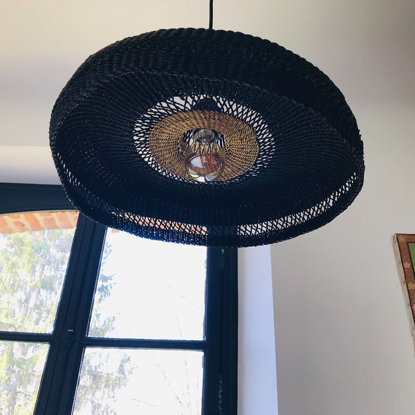 Unique sombrero-shaped pendant light casts a mesmerizing glow indoors.