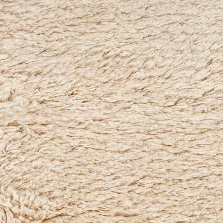 Close-up of fluffy, fibrous material resembling sheepskin or faux fur.