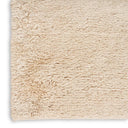 Plush cream-colored rug with soft, shaggy texture against white background.