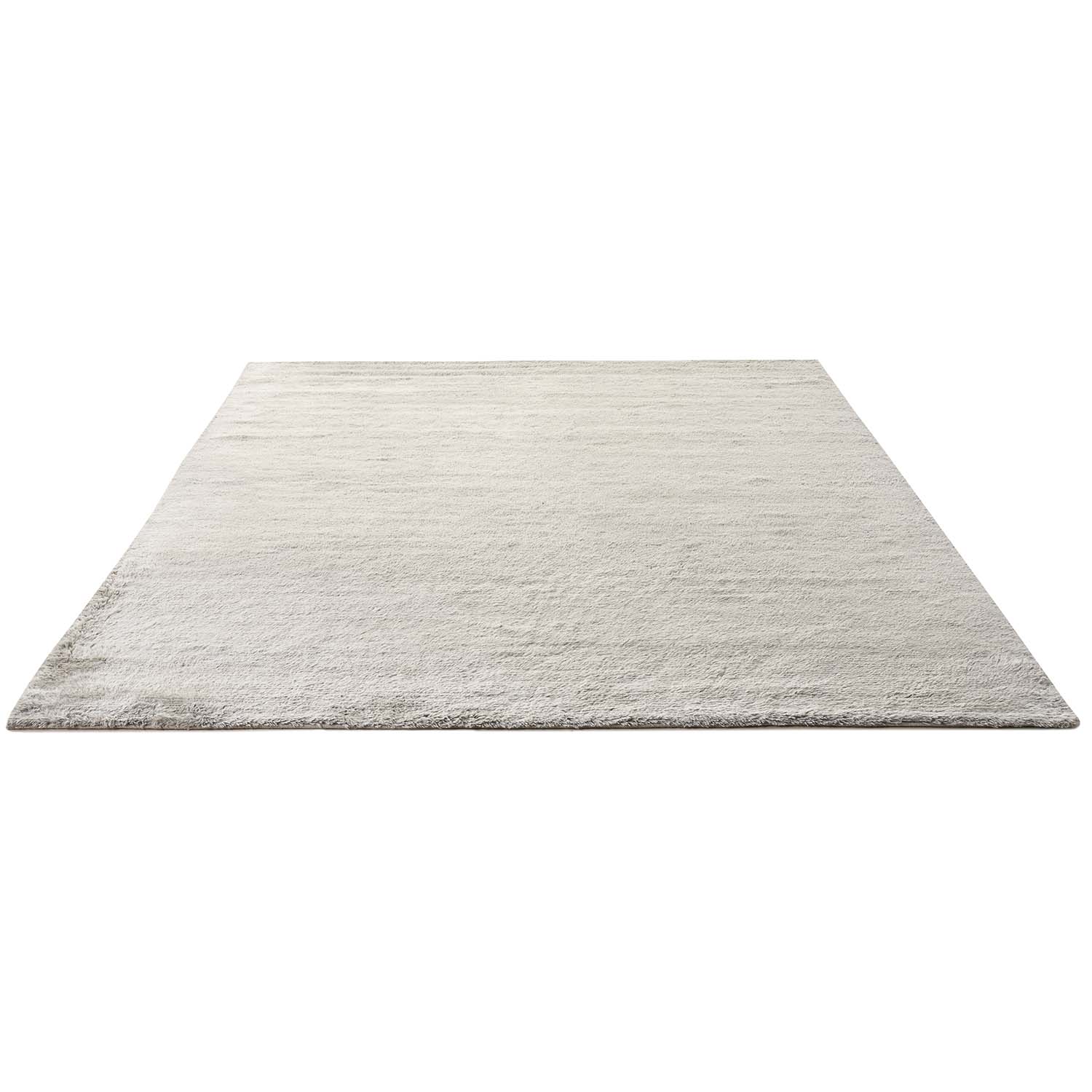 Simple, plain rug with soft texture in uniform light color.