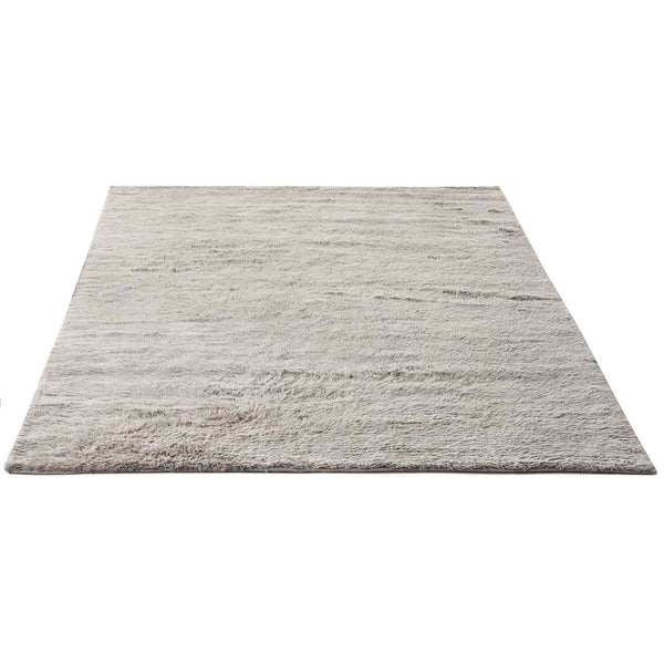Soft, plush area rug with a texture-rich, light-colored design.
