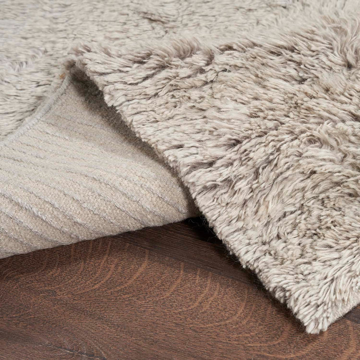 Close-up of a shaggy textured fabric and woven backing.