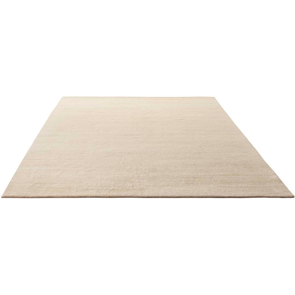 Plain, light-colored rug with subtle texture, perfect for minimalist interiors.