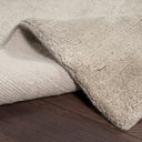 Cozy blanket with fluffy texture resting on a wooden surface.