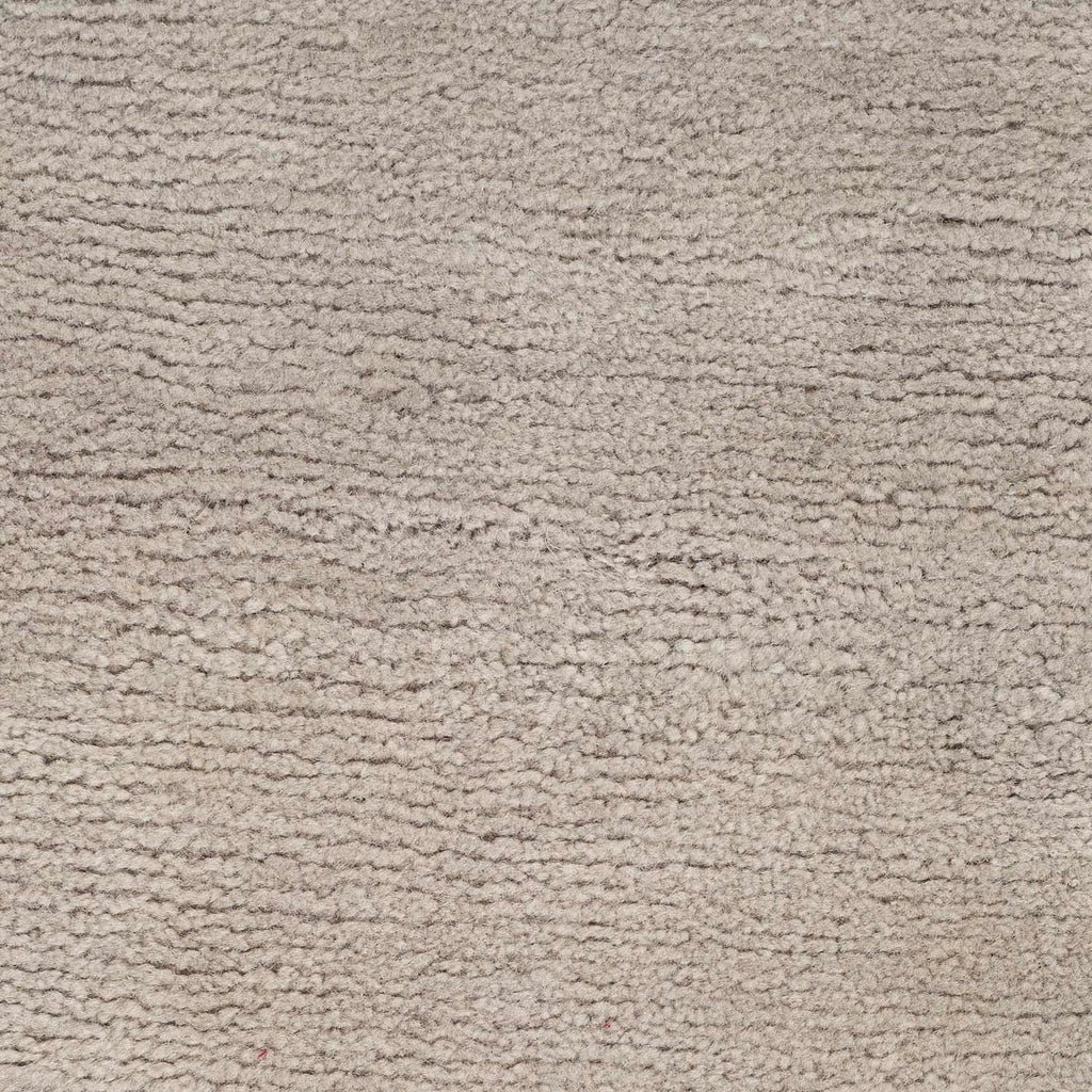 Close-up of a light grey, textured carpet after cleaning