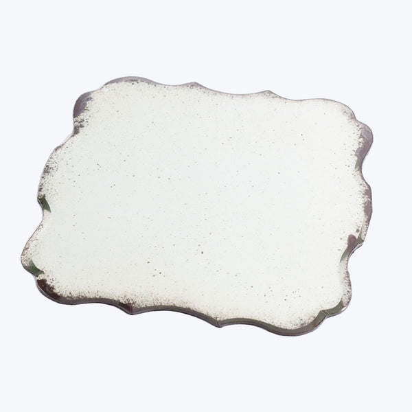 Viscous liquid with irregular shape on white background, potentially oil.