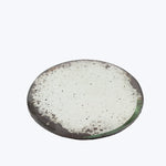 Worn and weathered metal plate with remnants of green paint.