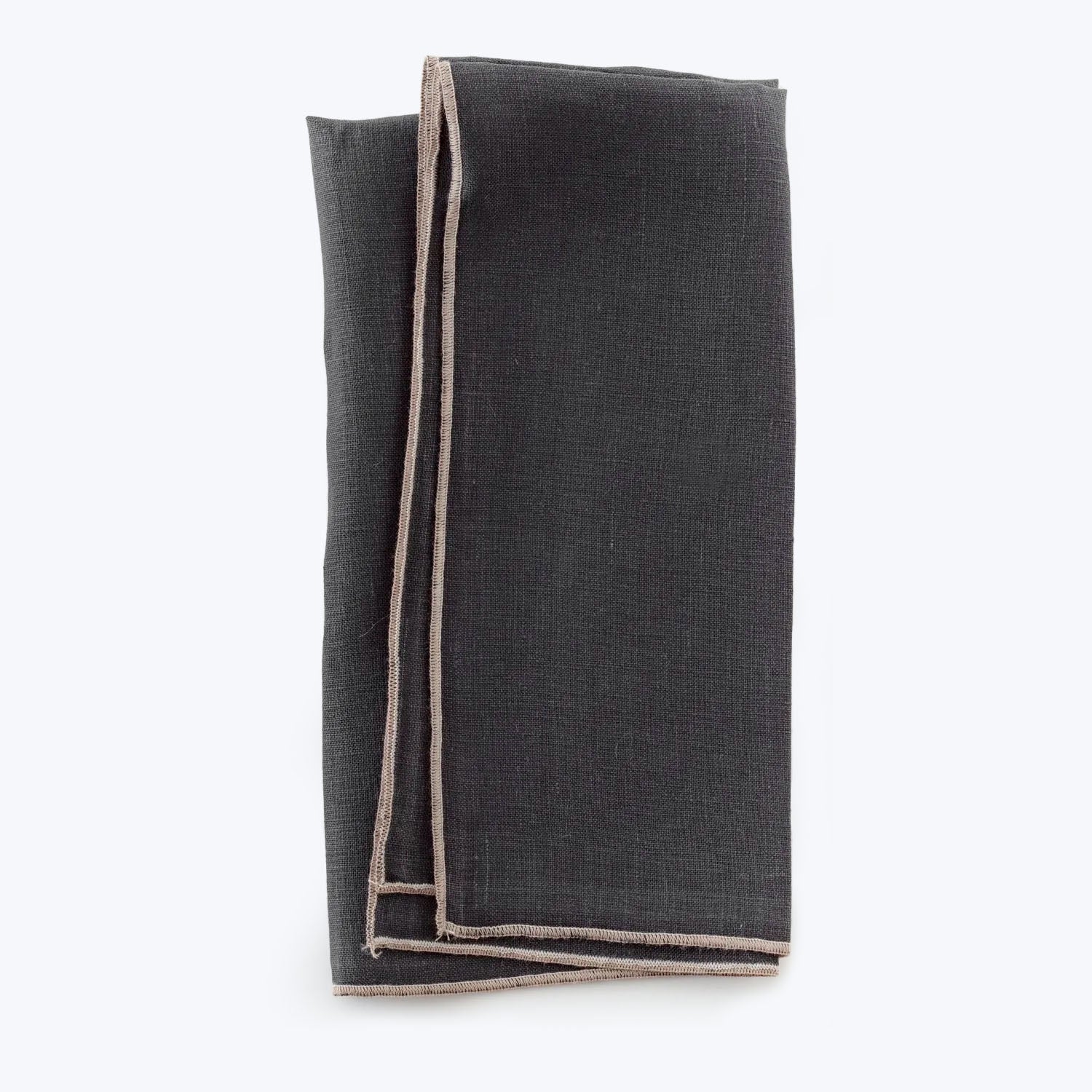 Folded dark fabric with contrasting hem against a white background.