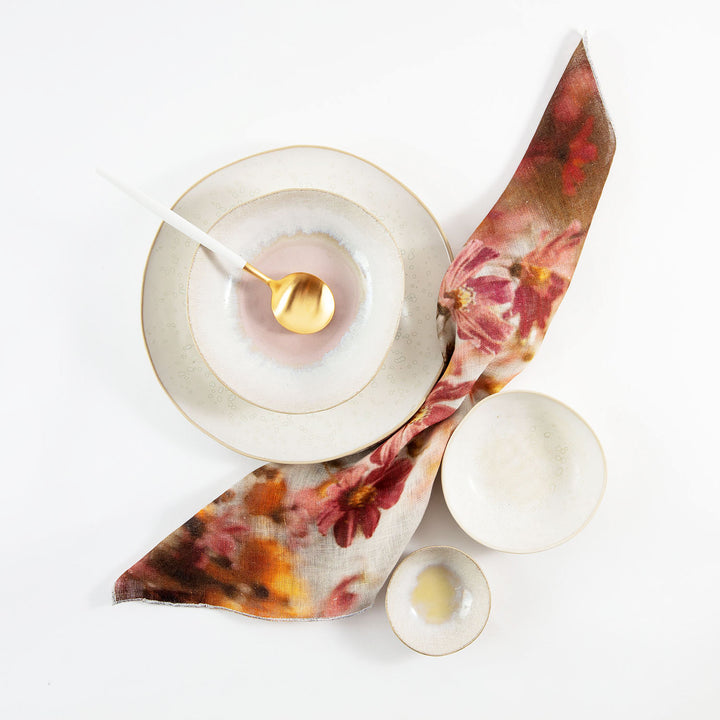 Neatly arranged still life composition featuring luxurious dishware and napkin.