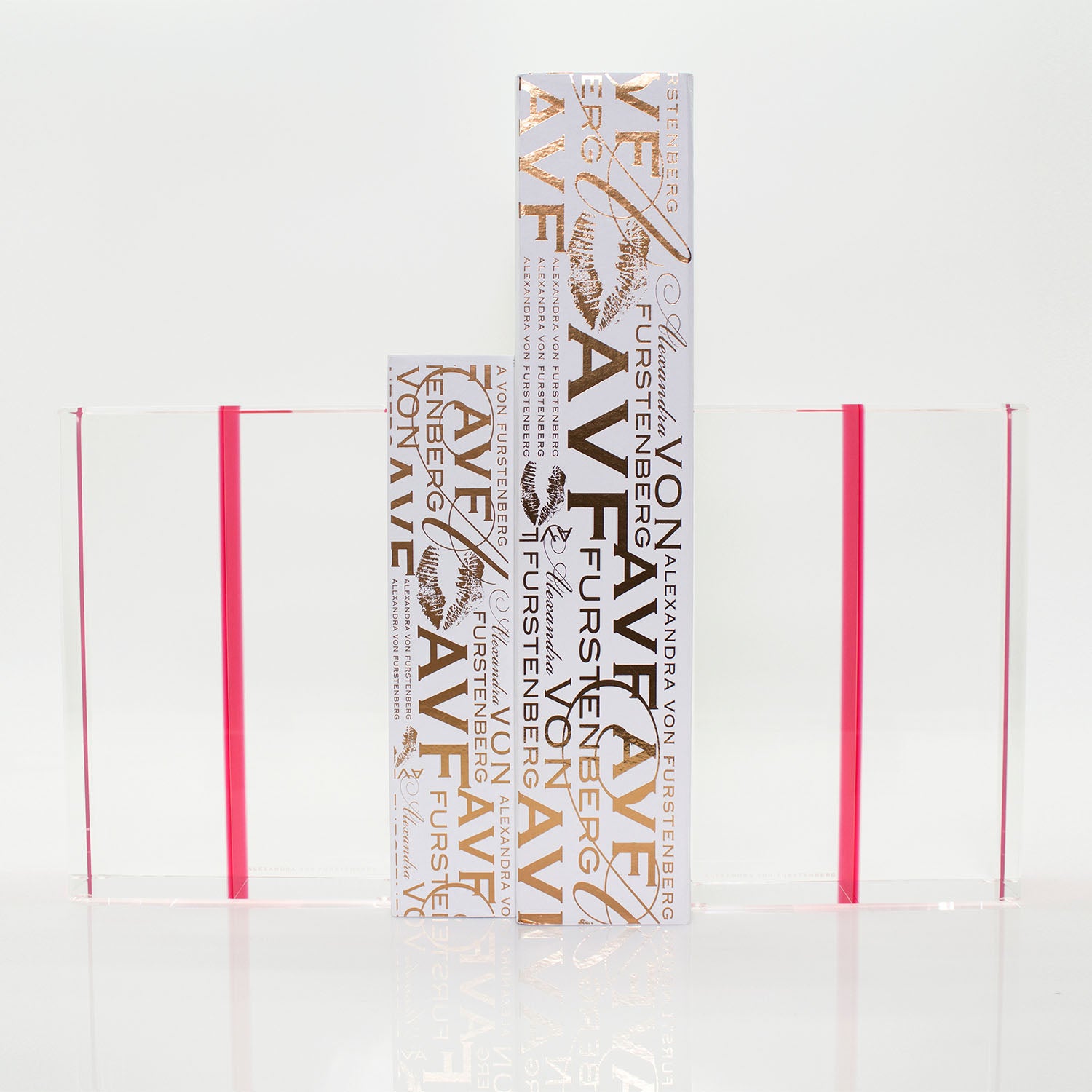 Three sleek rectangular packaging objects with reflective gold text and patterns.