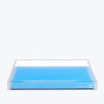 Minimalist transparent tray with blue base, versatile for various purposes.