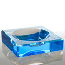 Vibrant blue acrylic block with a magnifying lens depression.