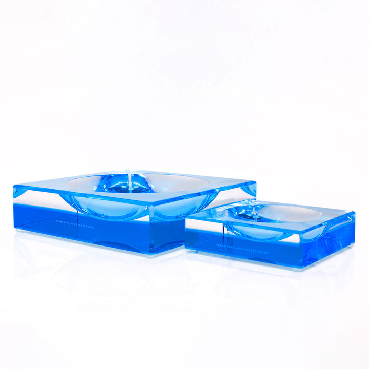 Sleek, transparent blue blocks with circular indentations for organization.
