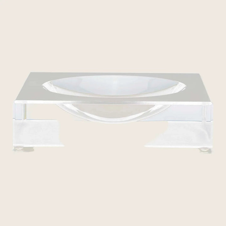 Clear acrylic box with engraved name, accompanied by minimalist dish.