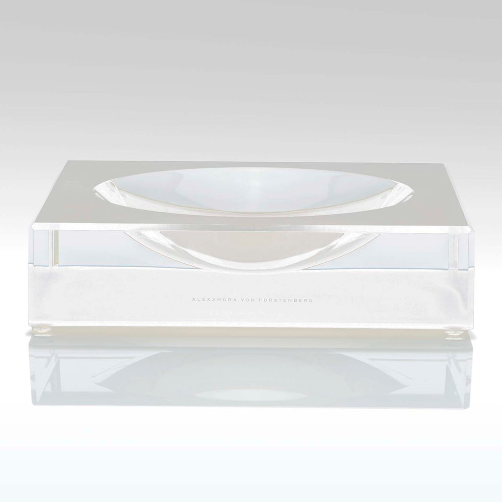 Clear acrylic box with engraved name, accompanied by minimalist dish.
