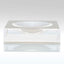 Clear acrylic box with engraved name, accompanied by minimalist dish.