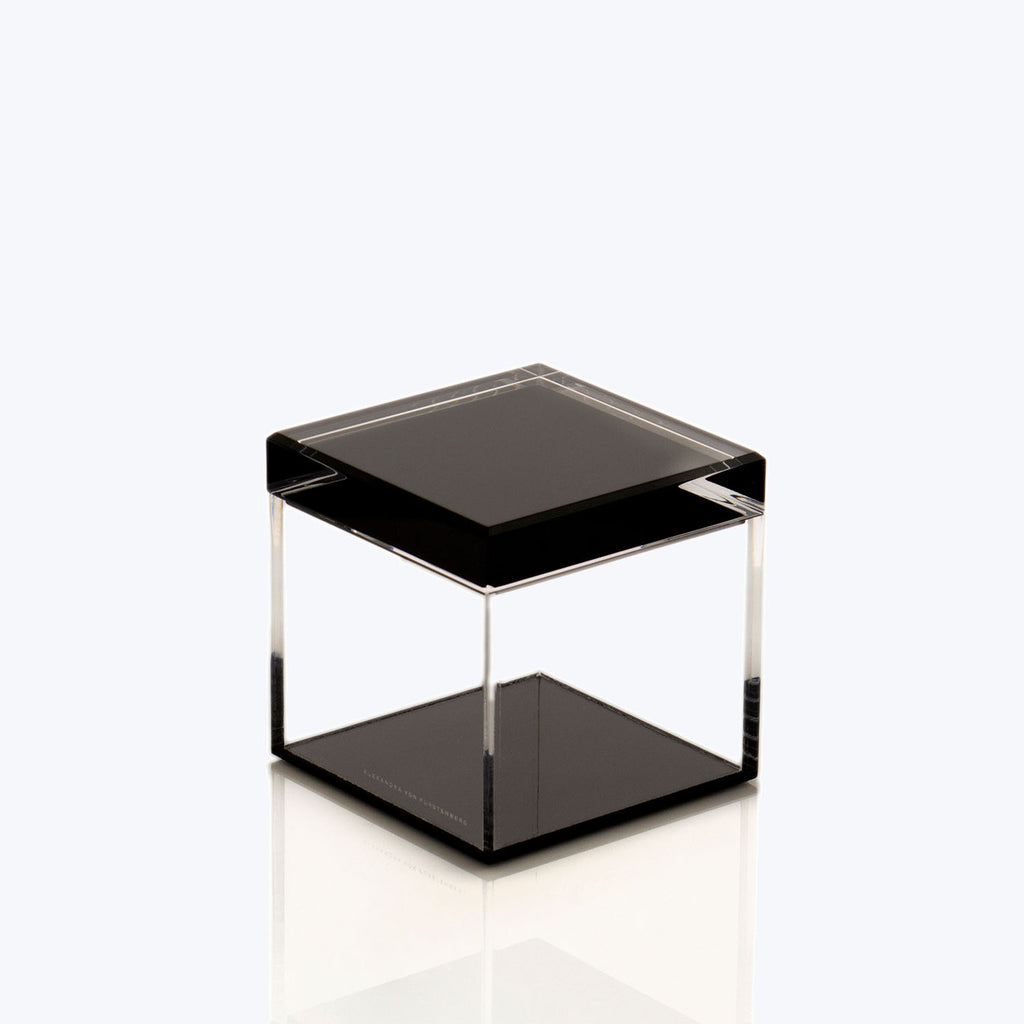 Transparent cube with black square, showcasing minimalist modern decor.