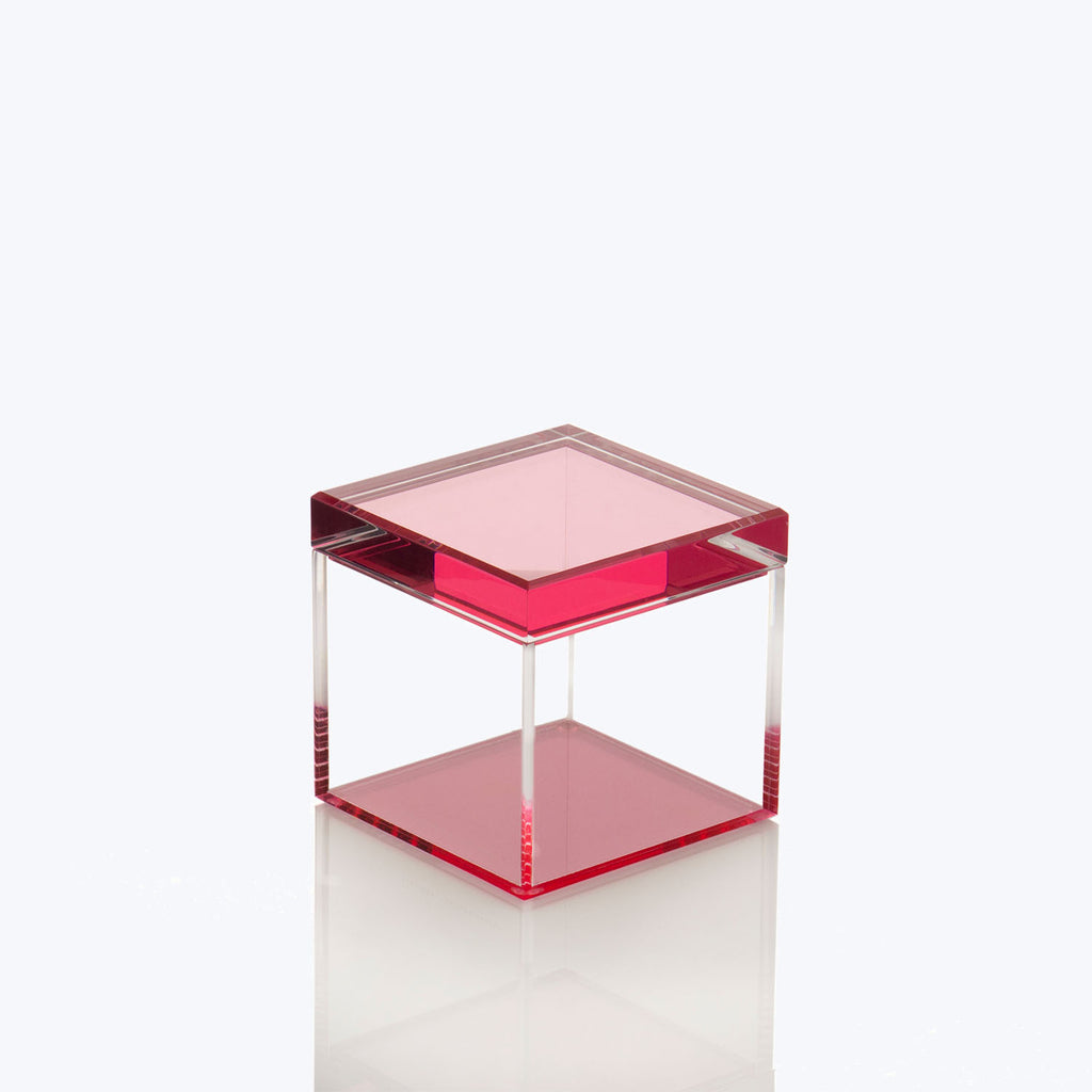 Minimalist table with translucent red accents creates a sleek design