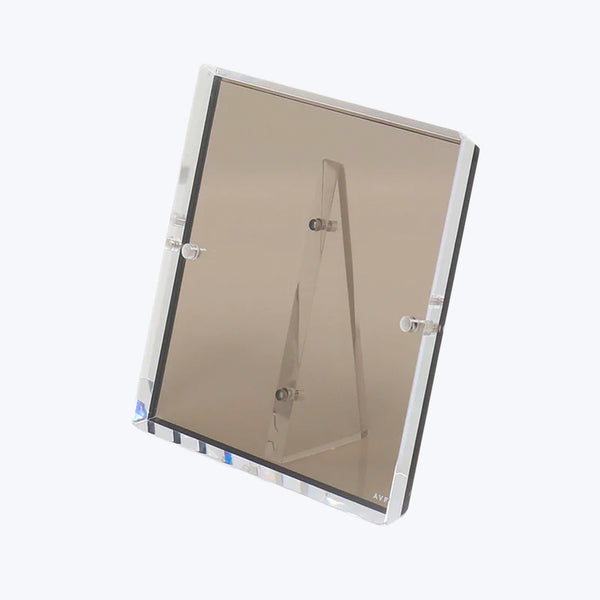 Modern acrylic tabletop mirror with adjustable A-frame stand and beveled edges.