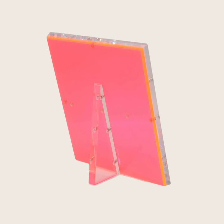 Translucent red acrylic panel with polished edges stands upright gracefully.