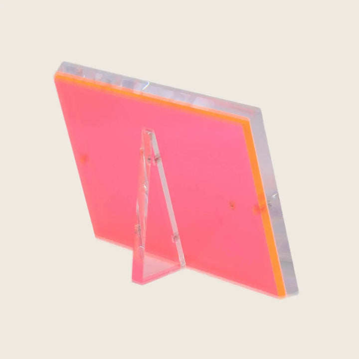 Fluorescent pink acrylic table tent with slanted design for menus.