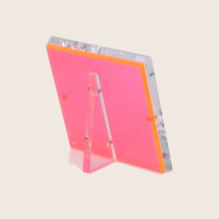 Neon pink acrylic sign holder in modern L-shape design.