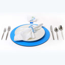 Formal place setting with blue accents suggests elegant dining event.