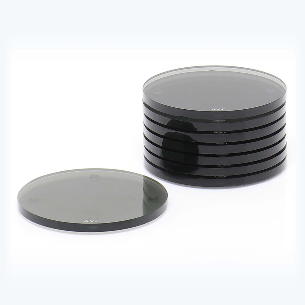 Stack of precision-cut, reflective circular components used in technical settings.