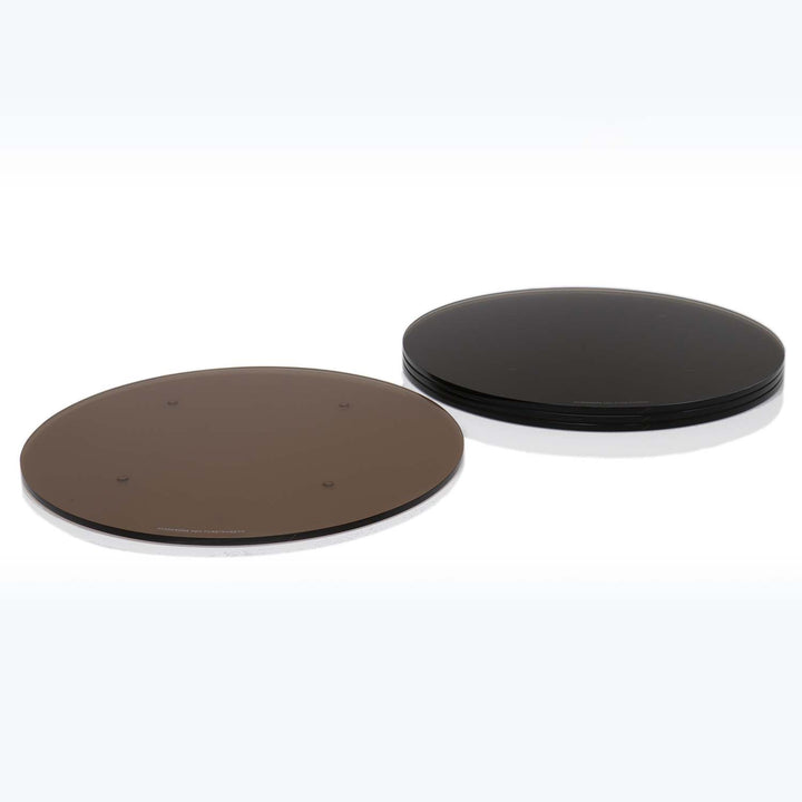 Two sets of circular objects - a single brown one, and a stack of black ones.