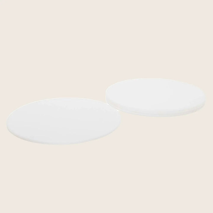 Two identical white plates with a minimalist and modern design.