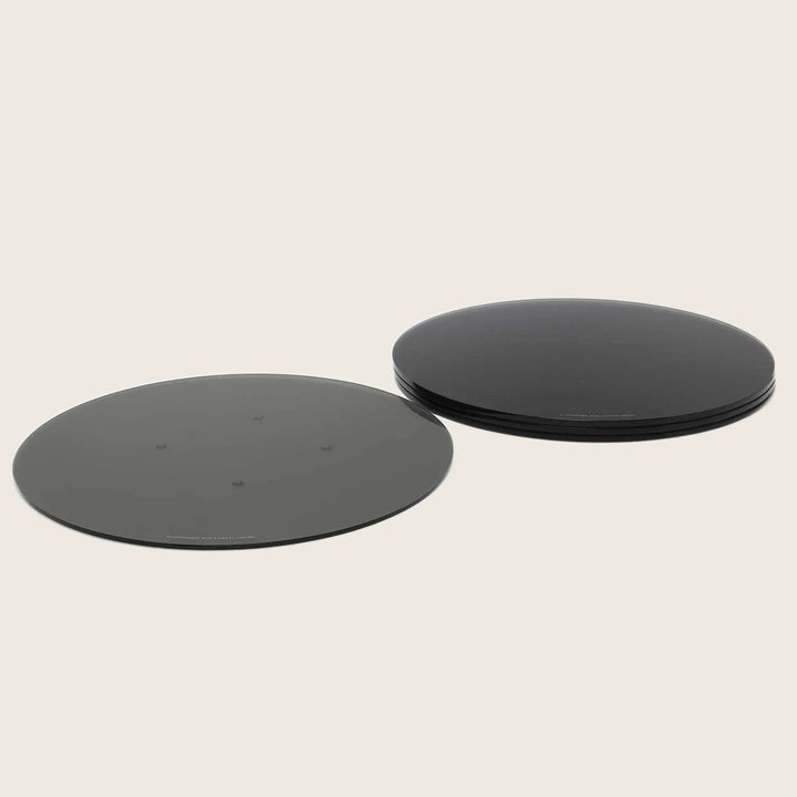Two circular objects, one flat and matte, one glossy and stacked.