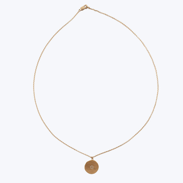 Delicate gold necklace with simple design and gem detail pendant