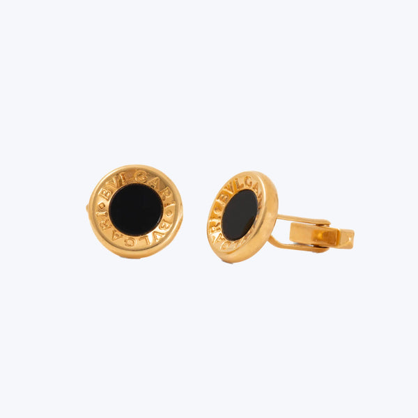 Gold-tone cufflinks with black inlay and embossed brand name
