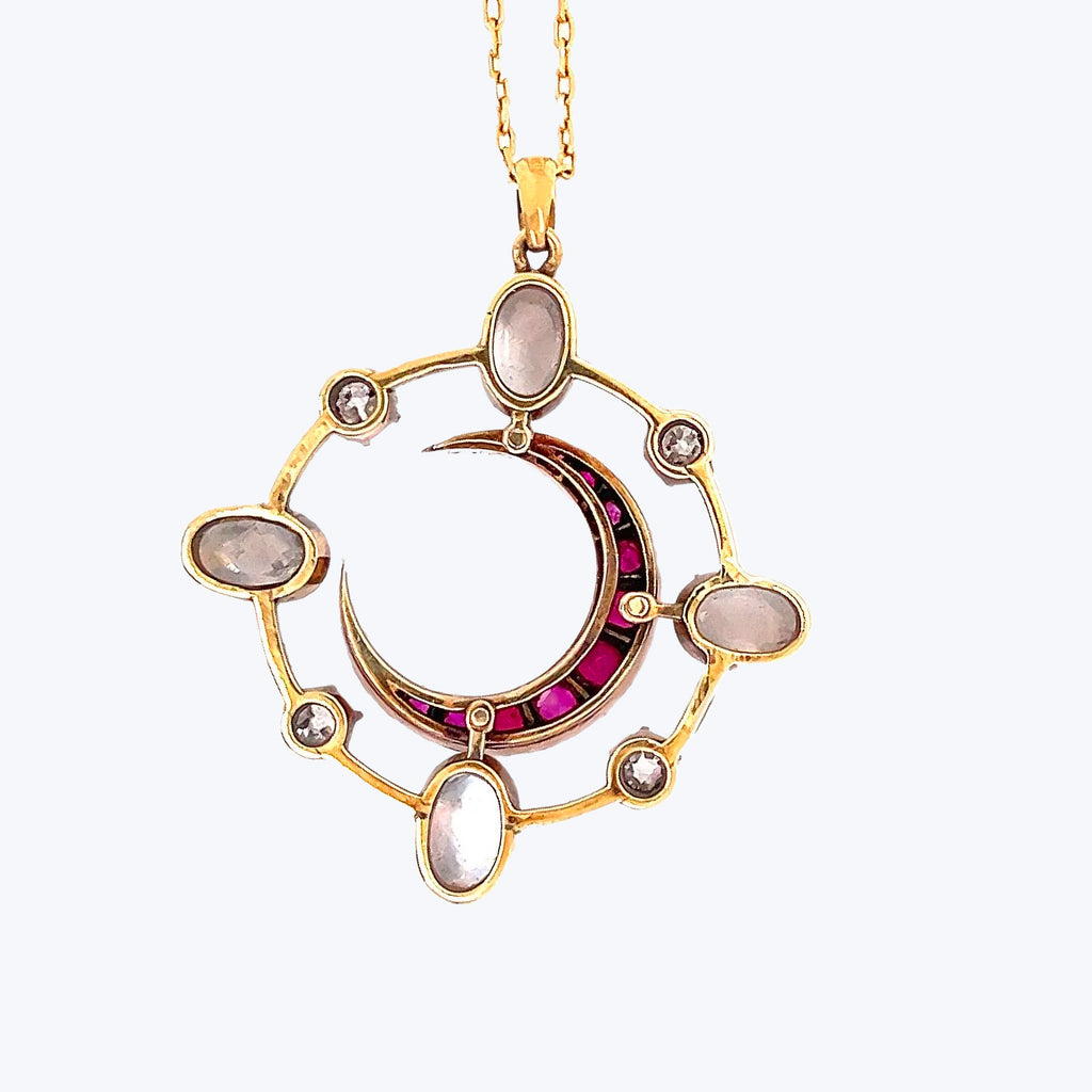 Elegant vintage pendant with gemstones and gold chain necklace design.