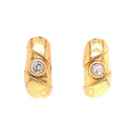 Stunning gold earrings with central diamond-like stones exude elegance.