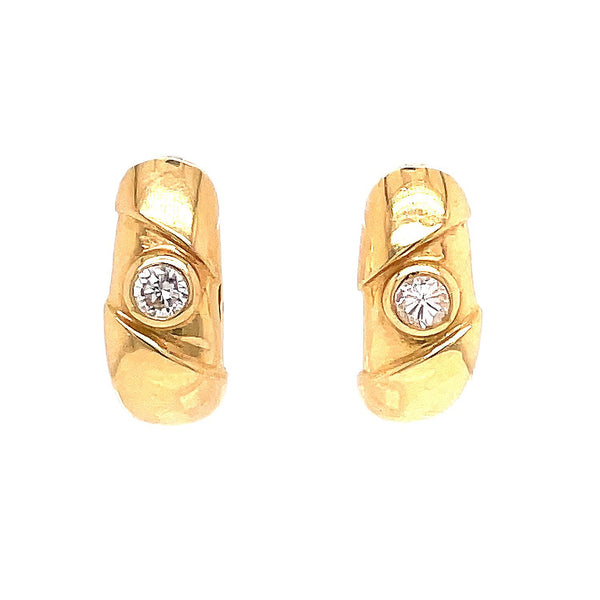 Stunning gold earrings with central diamond-like stones exude elegance.