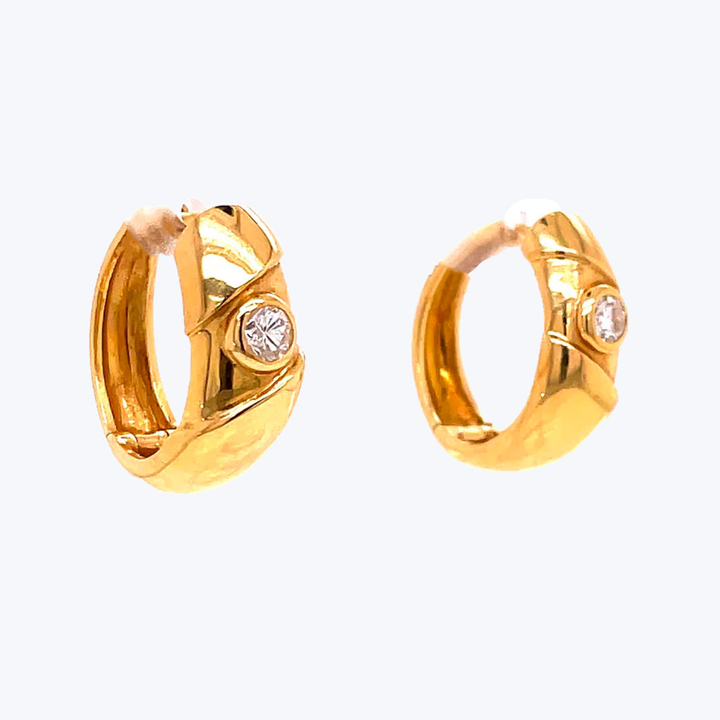 Gold hoop earrings with diamond-like gemstones, perfect for any occasion.