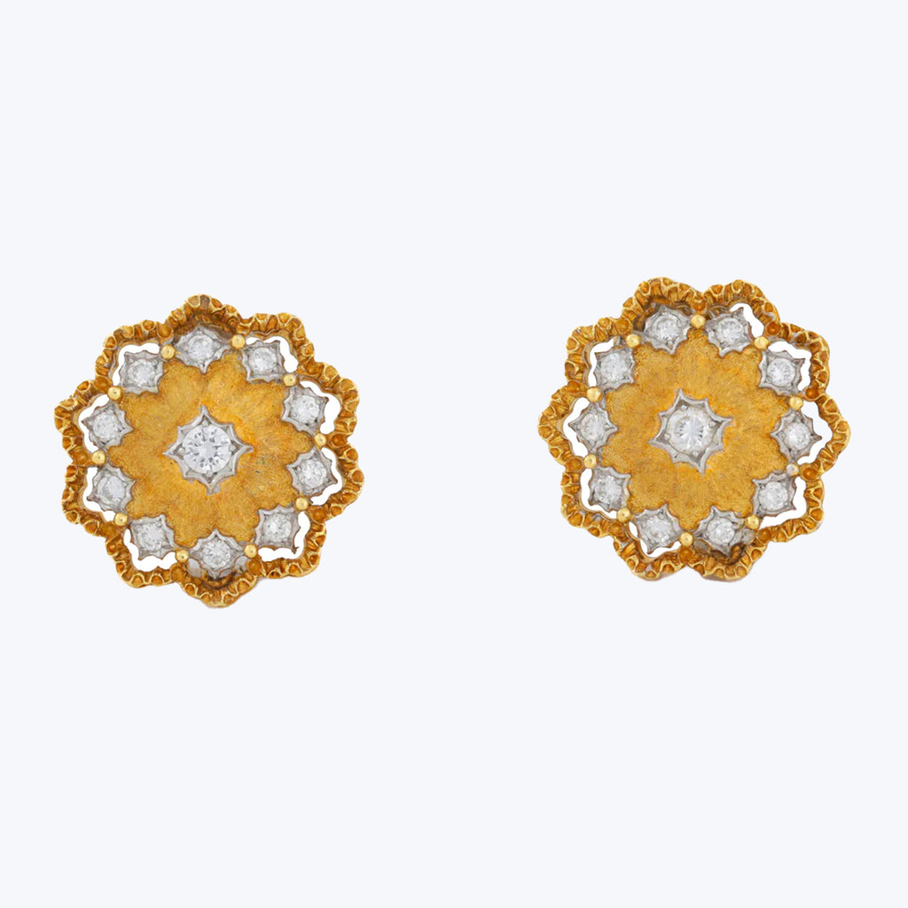 Exquisite floral-inspired earrings with yellow perimeter and diamond-like accents.